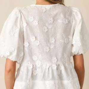 White sweet puff sleeve top with 3D floral embroidery and ruffle hem detail back view