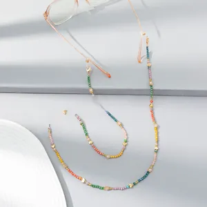 Close-up of rainbow beaded eyewear chain with gold heart accents and silicone grips