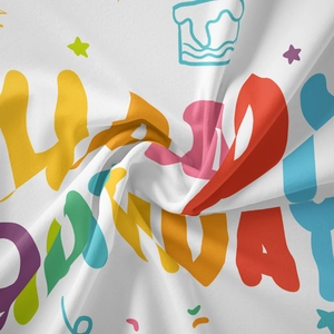 Detailed close-up of colorful Happy Birthday printed fabric with stars and cake icons