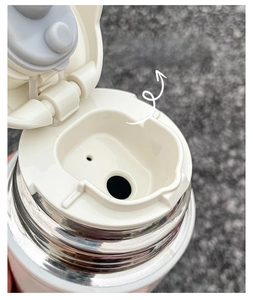 Close-up of the ergonomic U-shaped spout design on a stainless steel vacuum bottle