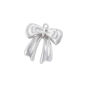 Close-up of polished silver bow pendant with metallic texture and hanging loop detail