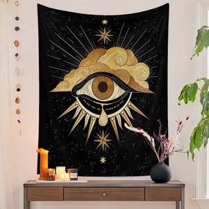 Detail of black tapestry with gold mystic eye and sun, showing rich fabric texture