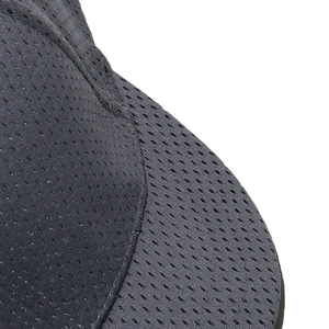 Close-up of black breathable mesh fabric and fine stitching on a short brim baseball cap