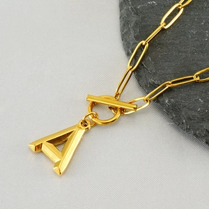 Golden OT toggle paperclip necklace with letter A pendant for women's elegant fashion wear