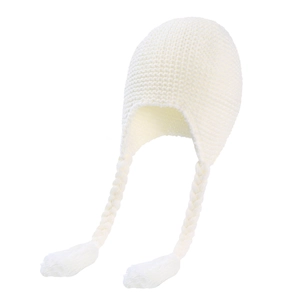 Detailed close-up of white knitted baby hat with braids and tassels on white background