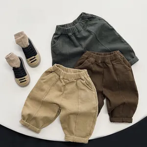 Flat lay of kids fleece casual pants in grey-green, dark brown, and khaki colors