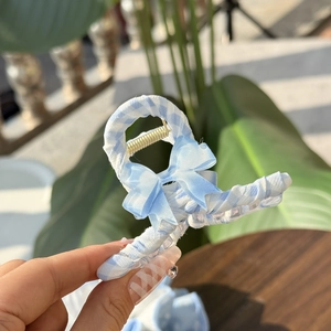 Blue and white gingham fabric hair claw clip with light blue bow and gold spring