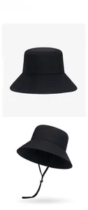Detailed view of black quick-dry sun hat with reinforced stitching and adjustable chin strap