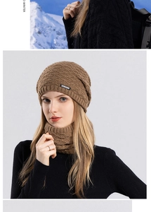 Close-up of winter knit hat and scarf set with JOYLORD logo in warm brown camel tone
