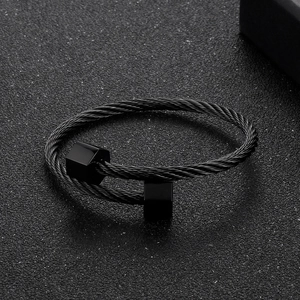 Macro shot of black twisted cable bracelet with hexagonal geometric steel ends