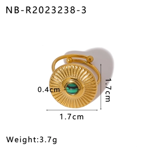 Detail of adjustable gold stainless steel ring with sunburst texture and green malachite