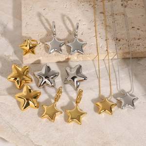 Polished 18k stainless steel star jewelry set with ring and earrings on stone background