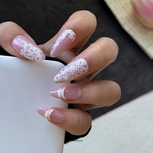 Pink almond press-on nails with white 3D flowers and tiny pearl accents for women
