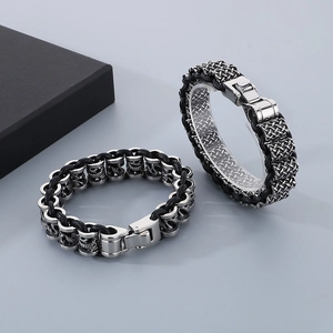 Close-up of punk style titanium steel braided leather bracelets for men with metal beads