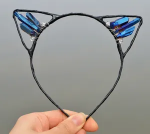 Macro detail of handmade cat ear headband featuring blue crystal clusters and wire wrapping