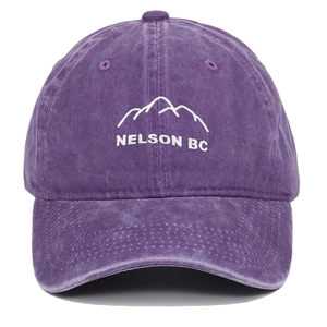 Close-up of purple washed cotton baseball cap featuring white mountain embroidery details