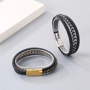 Close-up of multilayer braided leather bracelets with gold and silver magnetic clasps