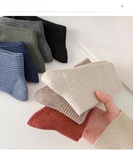 Close-up of ribbed cotton crew socks in a variety of classic solid colors for men