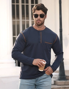 Detail of navy long-sleeve Henley shirt featuring yellow contrast stitching and pocket