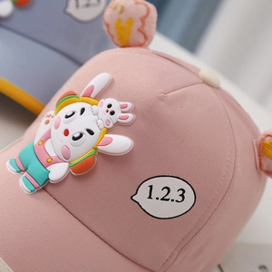 Pink cotton baseball cap for kids featuring a cute 3D silicone bunny with headphones
