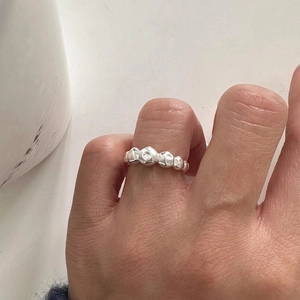 Minimalist 925 sterling silver ring with irregular liquid metal texture worn on hand