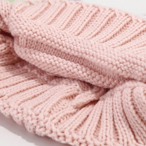 Pink knit winter beanie for kids with vertical ribbed pattern and soft texture detail