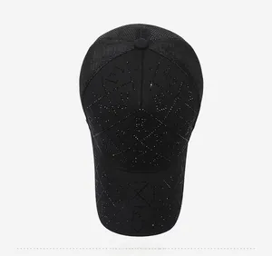 Detailed top view of a black baseball cap featuring rhinestone letters and mesh panels