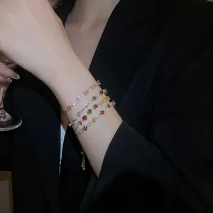 Adjustable gold bracelet set with colorful zircon stones in diamond and teardrop shapes