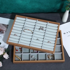Two-tier wooden jewelry display tray with grey velvet inserts for rings and earrings