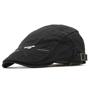 Detail of cotton flat cap with fashion metal emblem and side embroidery stitching