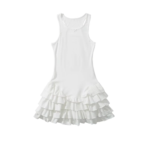 Detailed view of layered ruffle hem and tiered fabric on white sleeveless mini dress