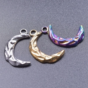 Detailed view of three crescent moon pendants with hammered texture and ring hooks