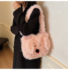 Detail view showing soft pink plush puppy tote bag with cute cartoon features and fuzzy texture
