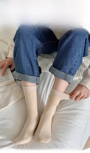 Close-up of 200N high-count yarn knitting texture on beige vertical striped crew socks