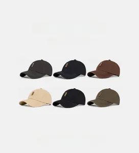 Detail view of washed cotton baseball caps in six vintage colors with small leather patches