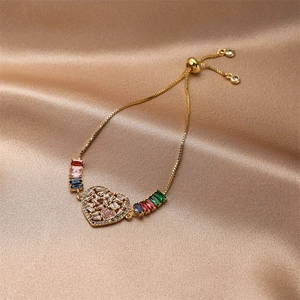 Detail of adjustable gold heart bracelet with multi-color cubic zirconia on silk
