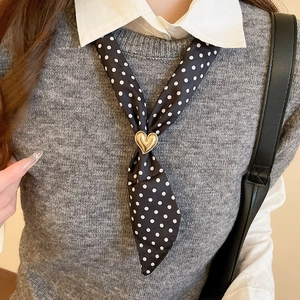 Polka dot fabric neck scarf with golden heart buckle detail worn on a model