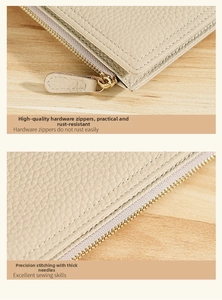 Close-up of gold metal zipper and precision stitching on beige lychee leather wallet