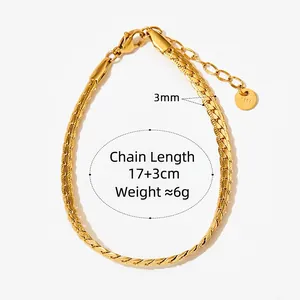 Flat gold curb chain bracelet with lobster clasp and round charm on white background