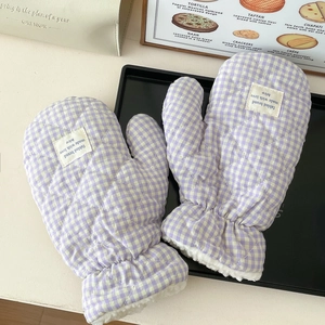 Close-up of purple quilted plaid gloves with cozy fleece lining and decorative label