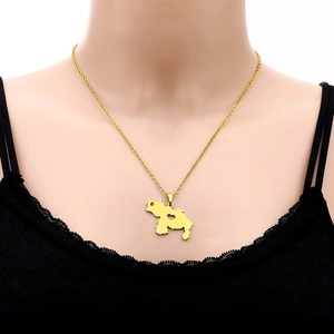 Close-up of gold Venezuela map necklace with heart cutout worn by a model