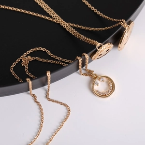 Close-up of gold smile pendant necklace with sparkling micro-pave zirconia details
