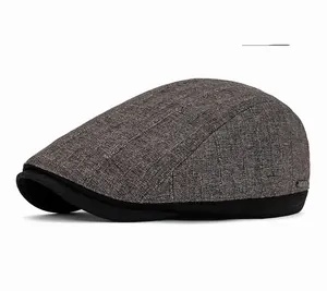 Detail of dark gray newsboy cap with textured knit fabric and black contrast brim