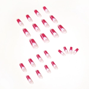Raspberry red gradient press-on nails with white heart patterns in long coffin shape