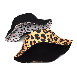 Reversible leopard print bucket hat for women in black and orange cotton fabric