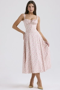 Detailed shot of white floral midi dress featuring delicate pink patterns and drawstring