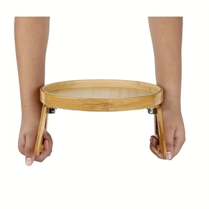 Close-up of portable folding bamboo sofa armrest tray with natural wood grain finish