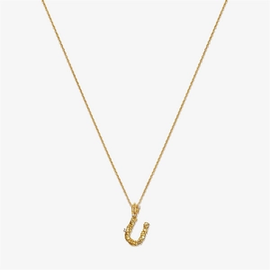 Detailed macro view of vintage gold S925 silver U-letter pendant with irregular texture