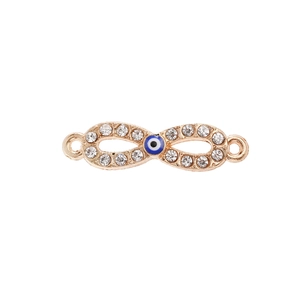 Macro detail of infinity evil eye connector with white rhinestones and gold plating