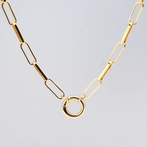 Close-up of a gold-plated chunky paperclip chain necklace with a circular ring clasp